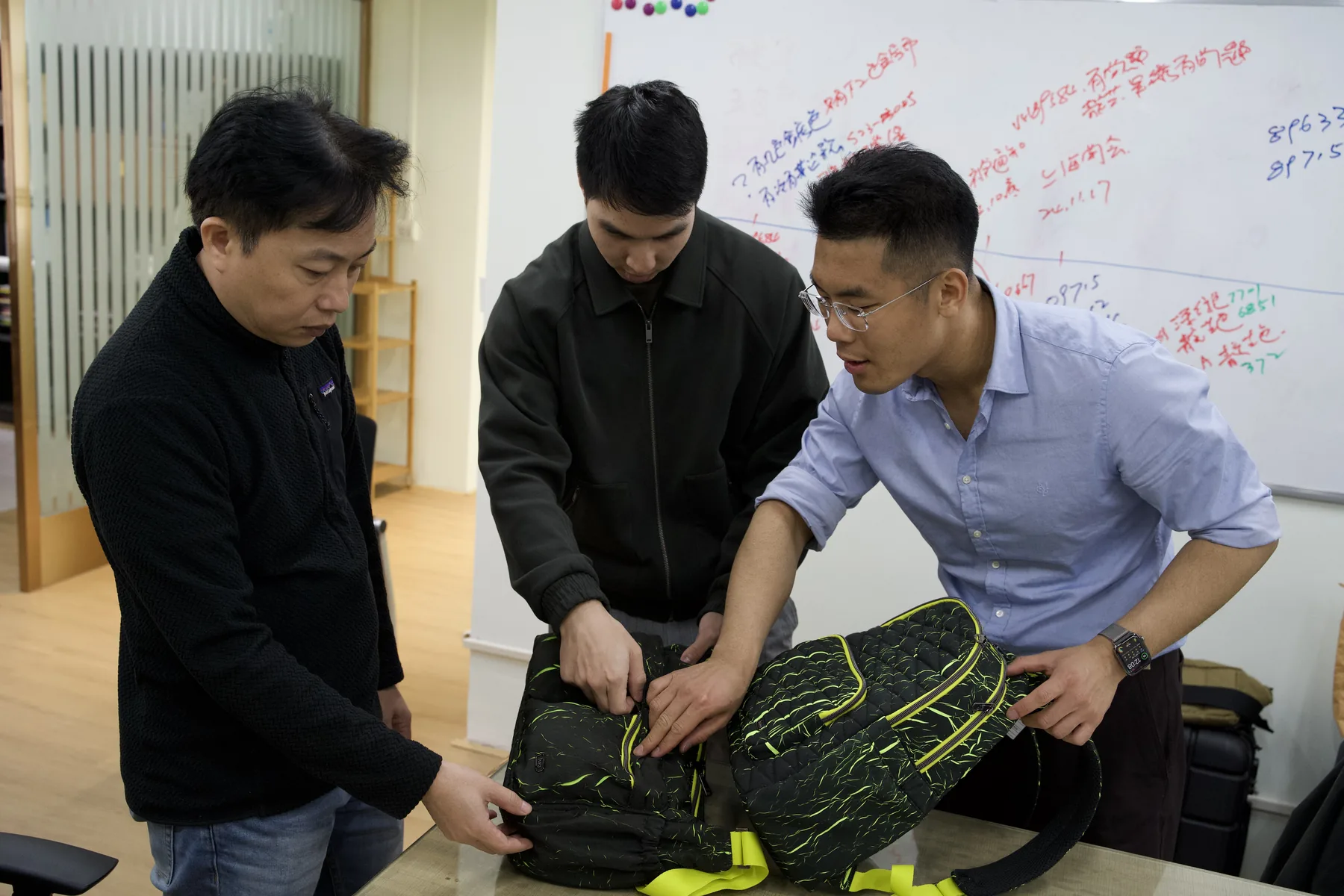ProtoBag Studio team reviewing a custom modular bag during a development consultation