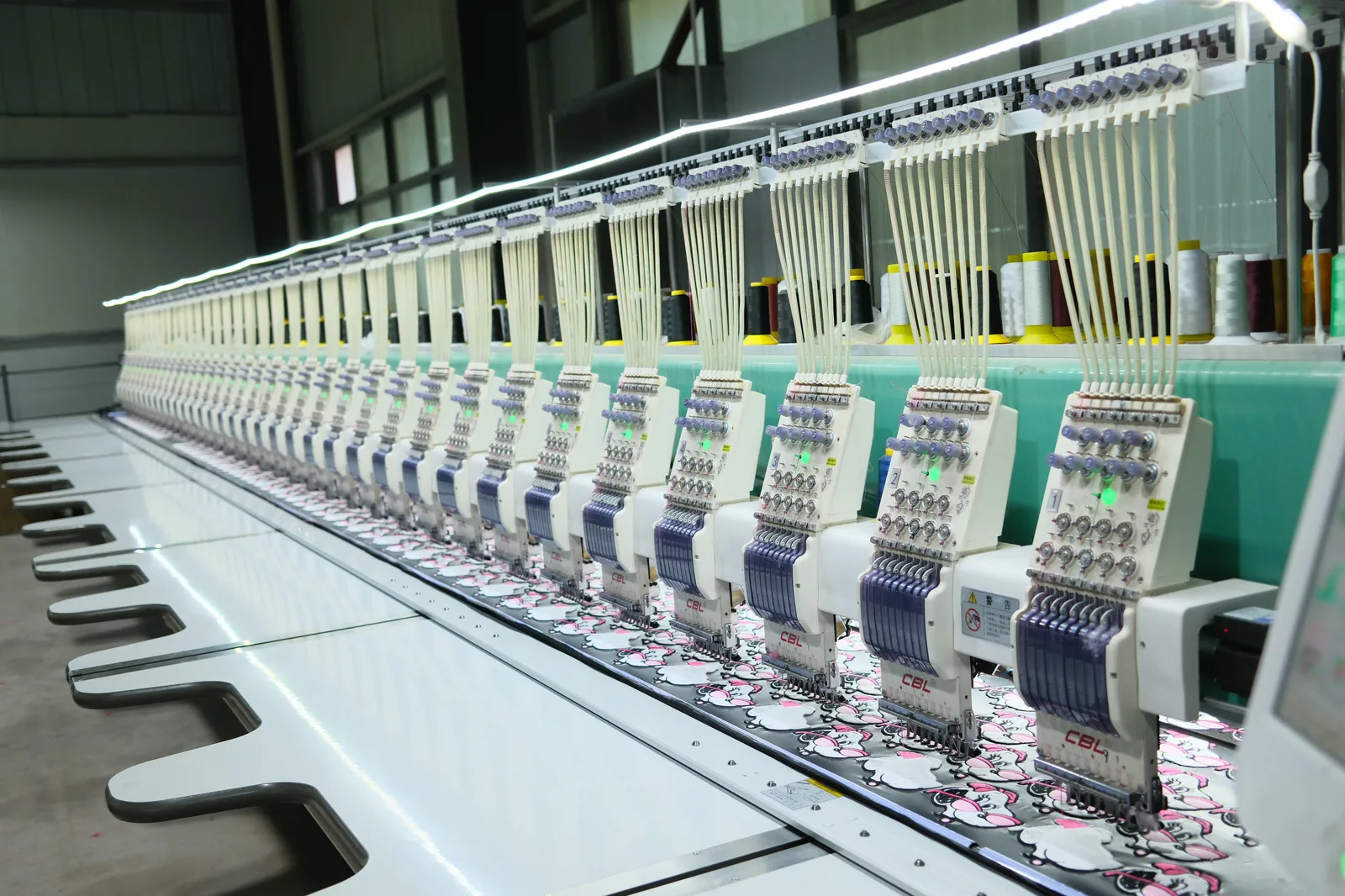 Wide shot of a bag-manufacturing factory floor showing multiple production lines