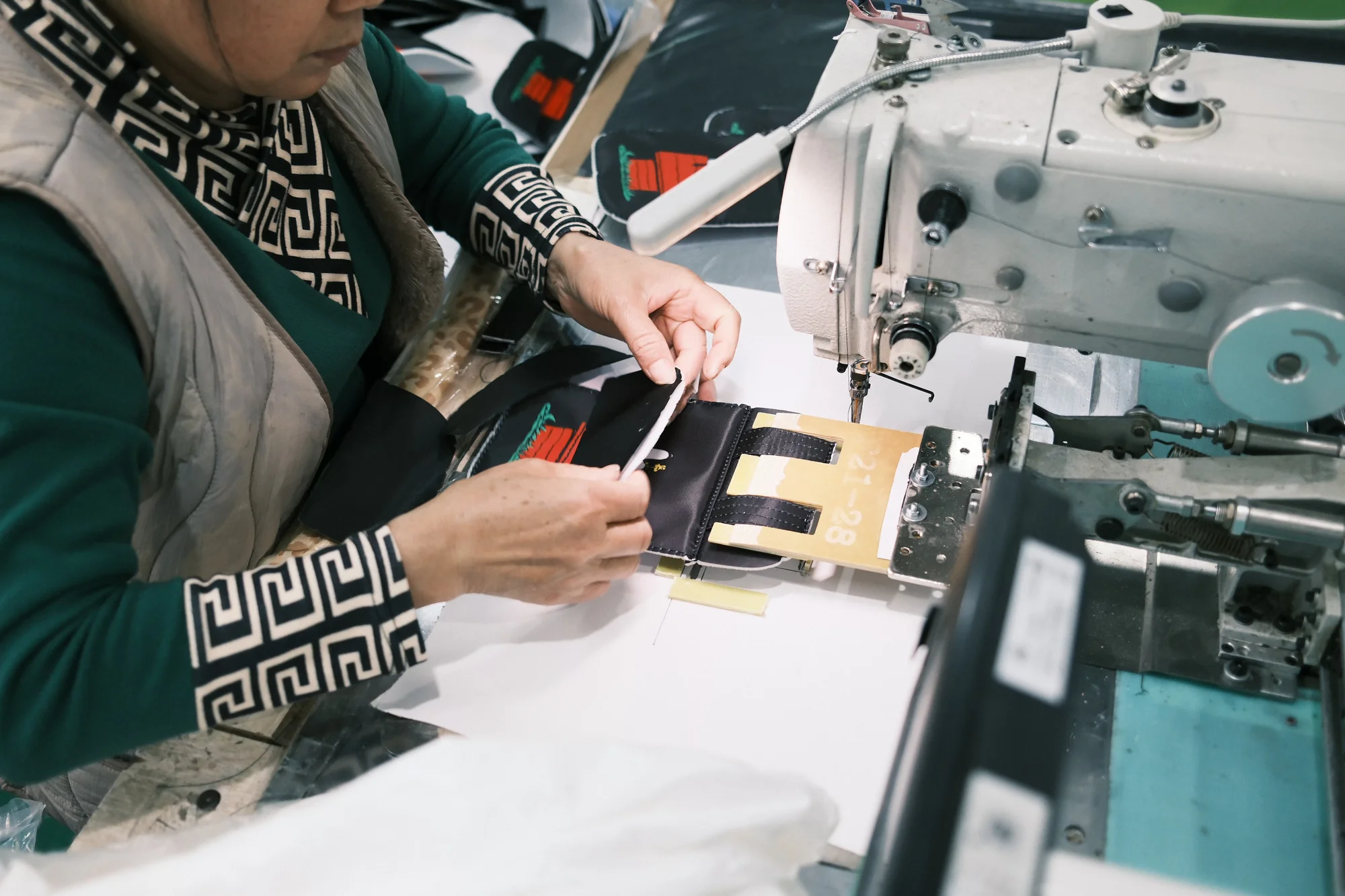 Close-up of a bag panel being stitched
